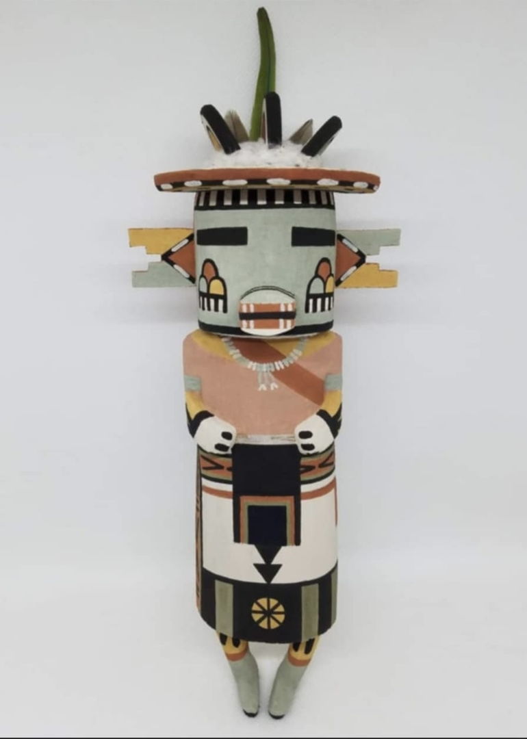 The Cloud Kachina is a symbol of all the different colored clouds that come from the four cardinal directions  he is also a symbol of moisture. the Cloud Kachina is carved out of dried aged cottonwood root  painted with natural earth mineral paints that I hand collect and process myself. Parrot feathers and natural cotton is used to complete the Cloud Kachina.