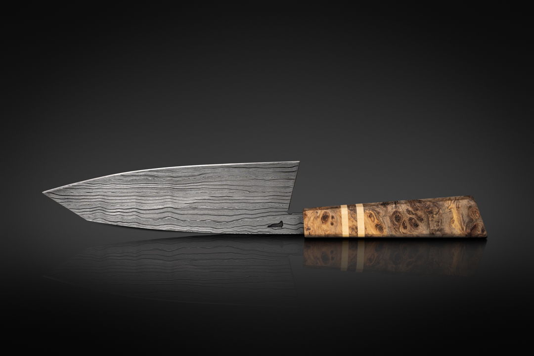 My seven inch chef knife  River Pattern Damascus is diffusion bonded by me from 26C3 and 15N20 Steels. Handle is made from Javanese Starfruit Burl with a pure white American Holly accent.