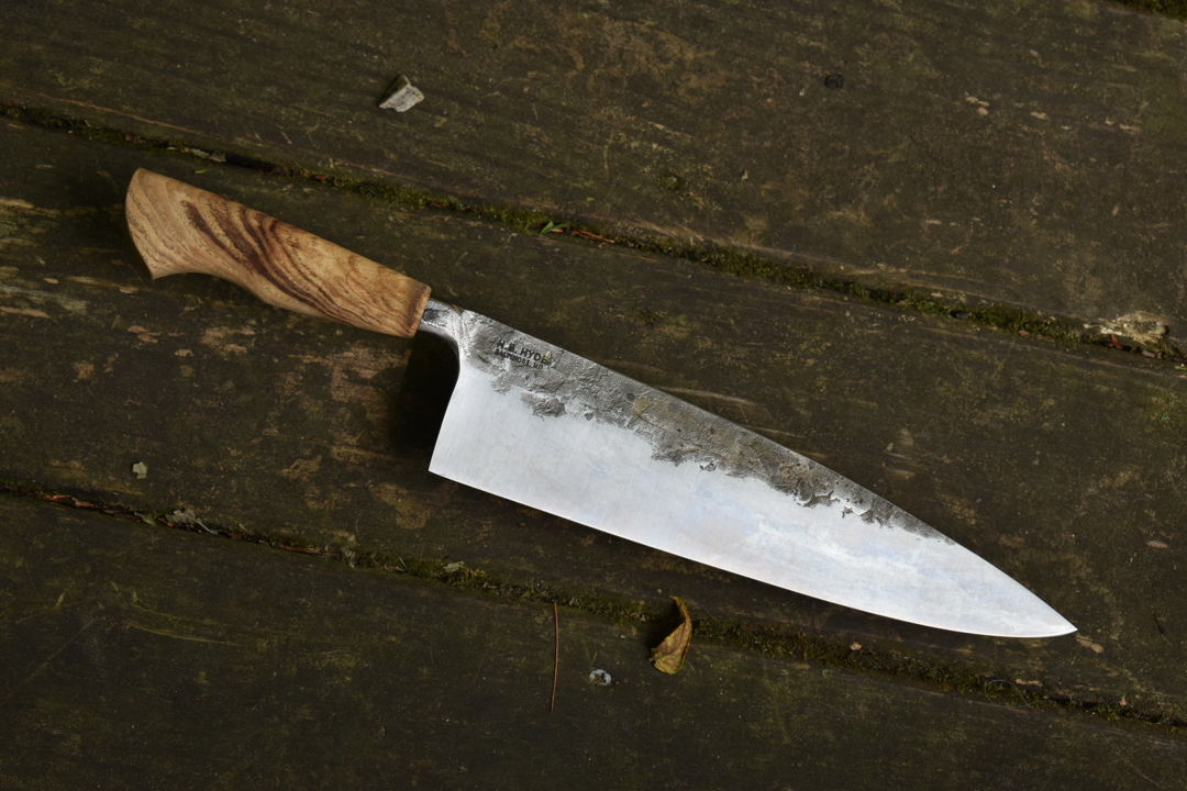 10.5" chef knife with Maryland Ash handle. The ash came from Camp Small  which is a lumber mill operated by Baltimore City. They take trees cut down around the city and turn them into useable lumber.