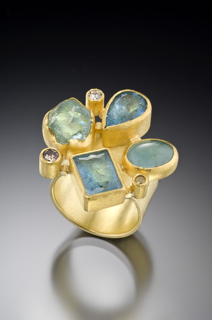 Mixed cut and shape aquamarines (6.37ct total) and white round VS2 diamonds set in mosaic style each in 22k gold bezels with 18k backing and spacers  on 18k 7mm band.