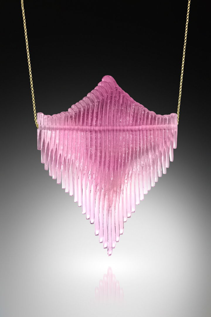 Digitally designed  waterjet cut glass  coldworked  polished  and locked onto an sterling silver inner tube that maintains the movement of the 33 individual pieces of glass when threaded onto its gold fill chain.