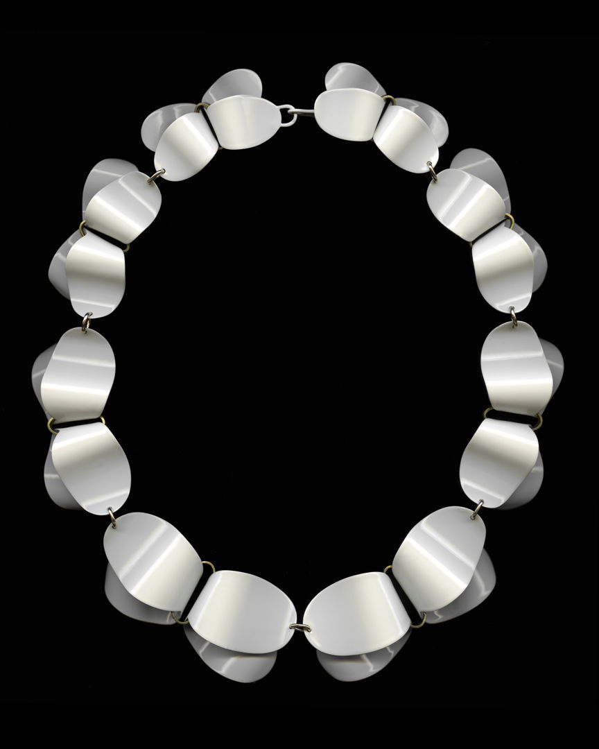 This necklace is part of my Folded Series and is hand cut brass  hand formed and then powder coated cream.