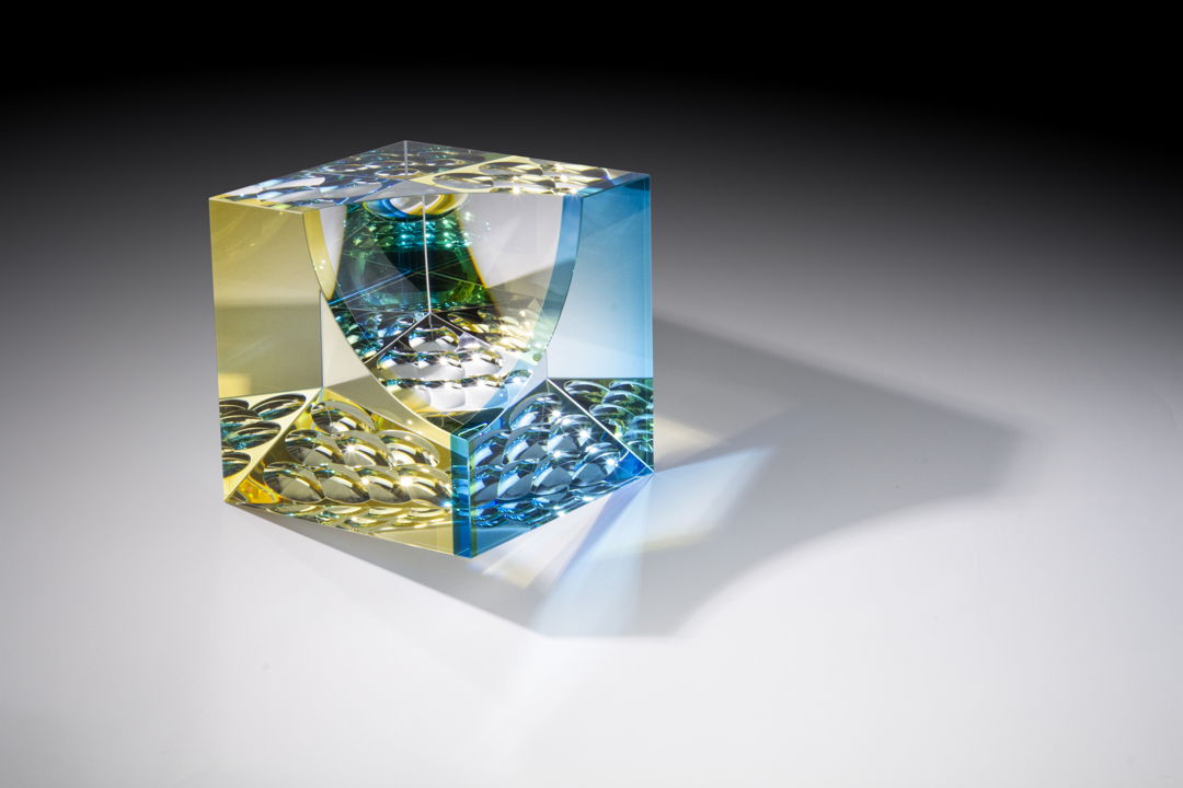 Optical glass that has been cold-worked: a centuries old Bohemian technique using no heat  but rather room temperature glass is shaped using water and abrasives in conjunction with lapidary tools. The techniques involved are cutting  grinding  polishing  laminating and coloring.