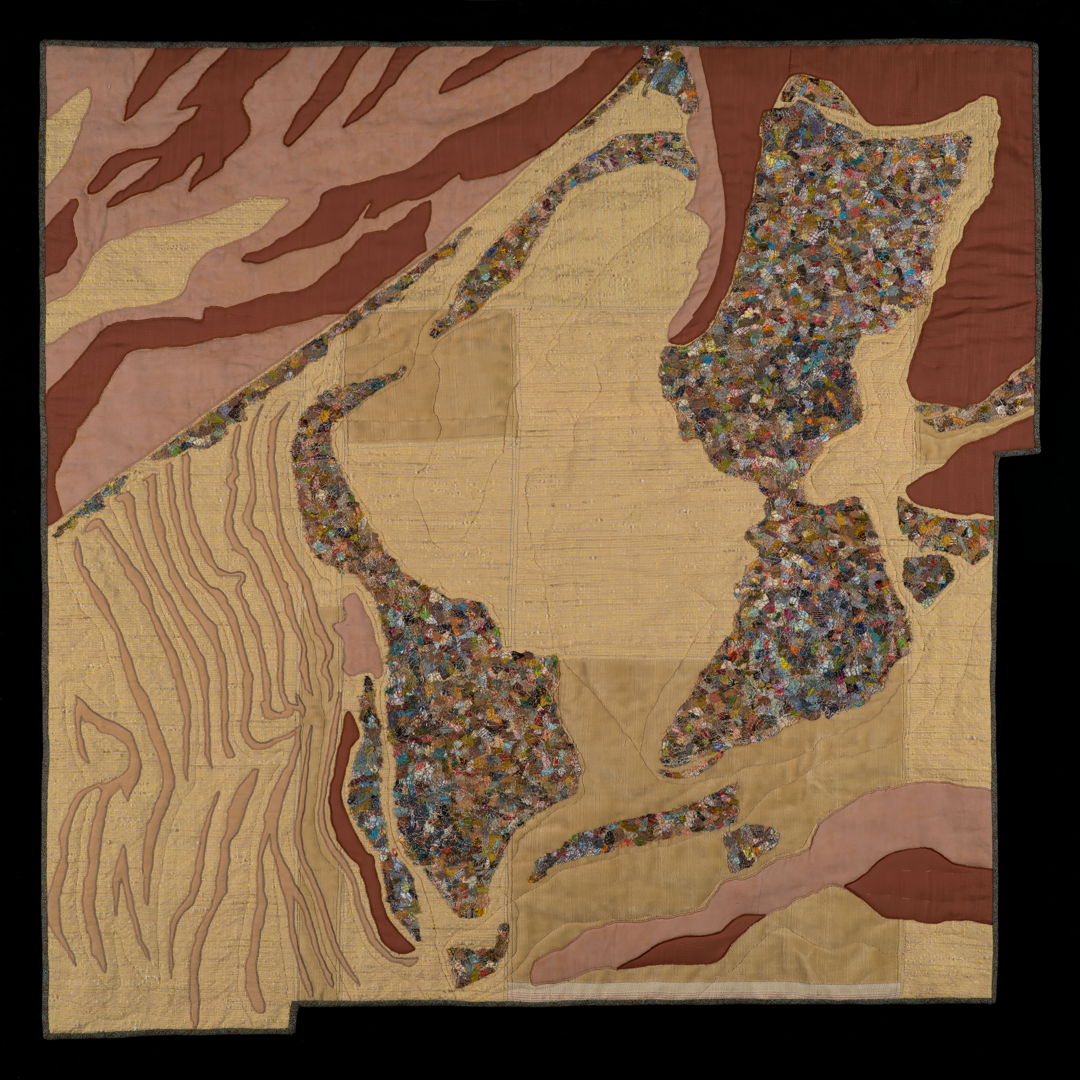 appliqued and quilted aeriel view and a trash dump in the desert.