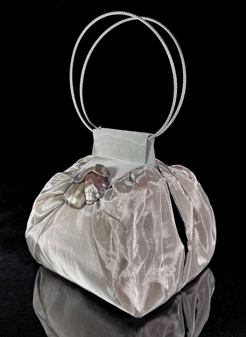Evening Handbag made of very fine  silk like stainless steel mesh with layer of copper mesh beneath. Handles of aircraft cable.