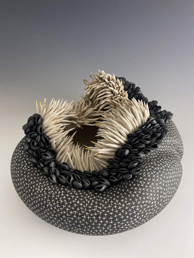 Hollow porcelain vessel carved with crosses and topped with clusters of anenome-like tenticles and mussel shells