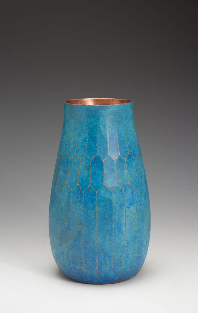 Hand-raised copper vase with chased facetted design and a vibrant teal patina