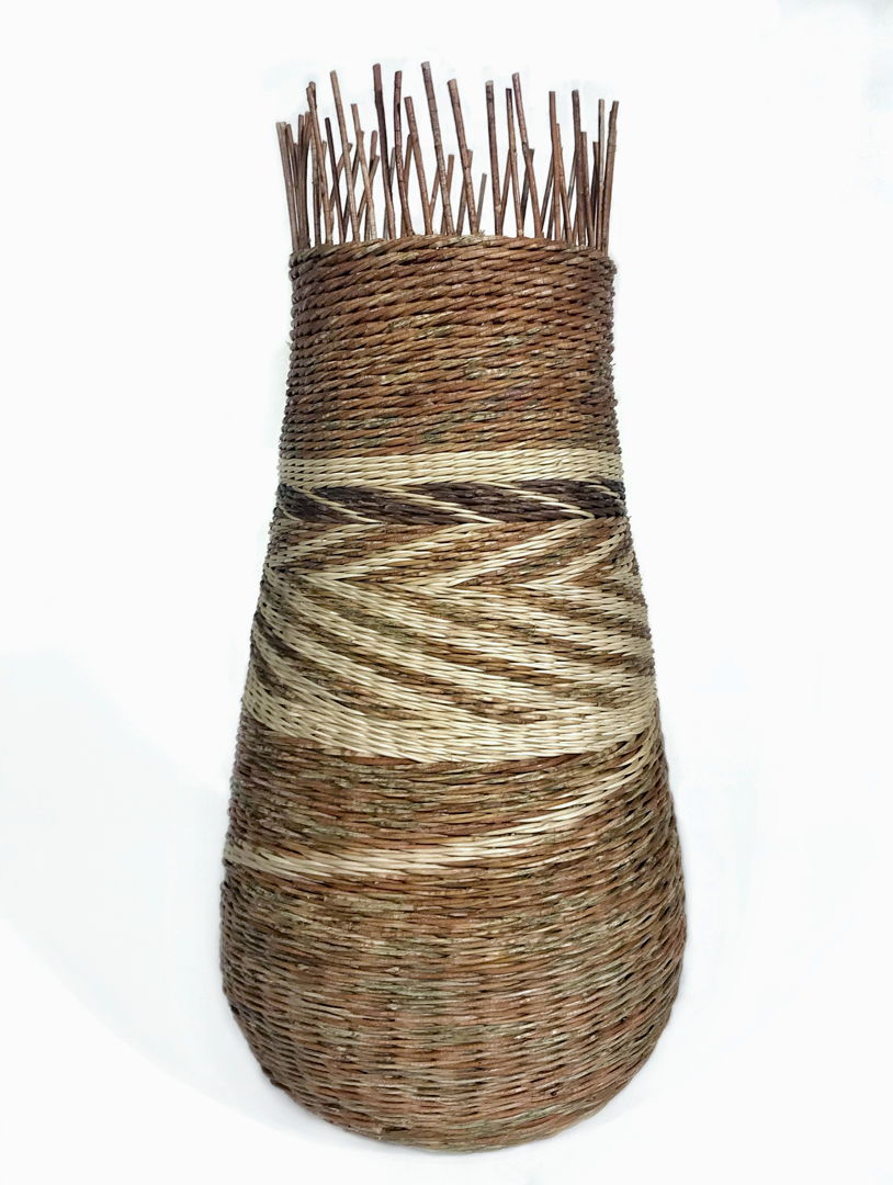 Rattan basket with the white, brown and gold tones creating a zig zap center band.