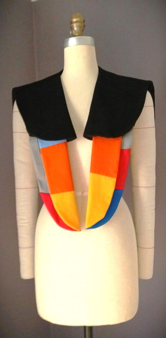 Veyna blends artistry and function  crafted from black wool and cotton with quilted wing-shaped panels. This shoulder wrap combines the richness of black wool with the softness of cotton  carefully layered into quilted  wing-inspired panels that evoke the grace of a bird in motion. Every detail is hand-finished  highlighting the artistry behind its creation and transforming fabric into a statement of wearable sculpture.