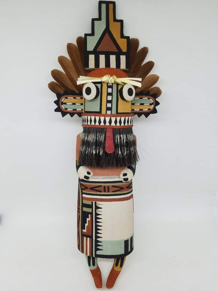 Carved from cottonwood root  painted with natural earth pigment paints. Other materials used  horse hair  yaccu plant and partridge tail feathers