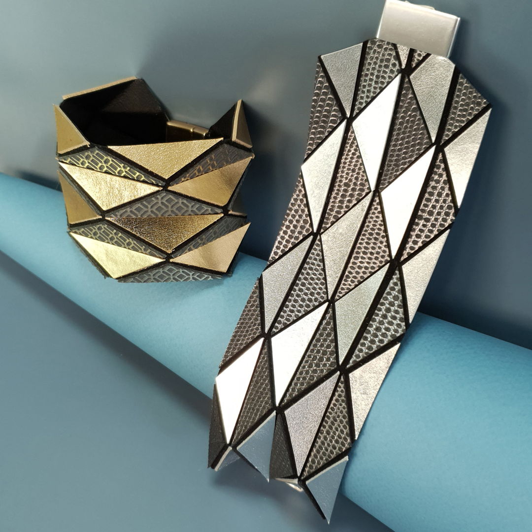 Art meets style in this contemporary gold and silver leather cuff bracelet. This bracelet is created using the geometric origami design. When you put it on  it magically transforms from a flat piece to a stunning three dimensional work of art.