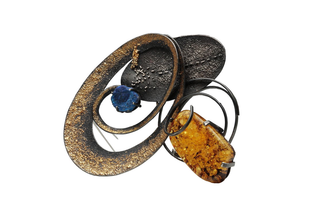 Expertly crafted through hammering and fusing  this jewelry piece harmonizes platinum  22k pink gold  24k gold  925 silver  amber  and azurite. Each element blends seamlessly  creating a mesmerizing fusion of texture and color.