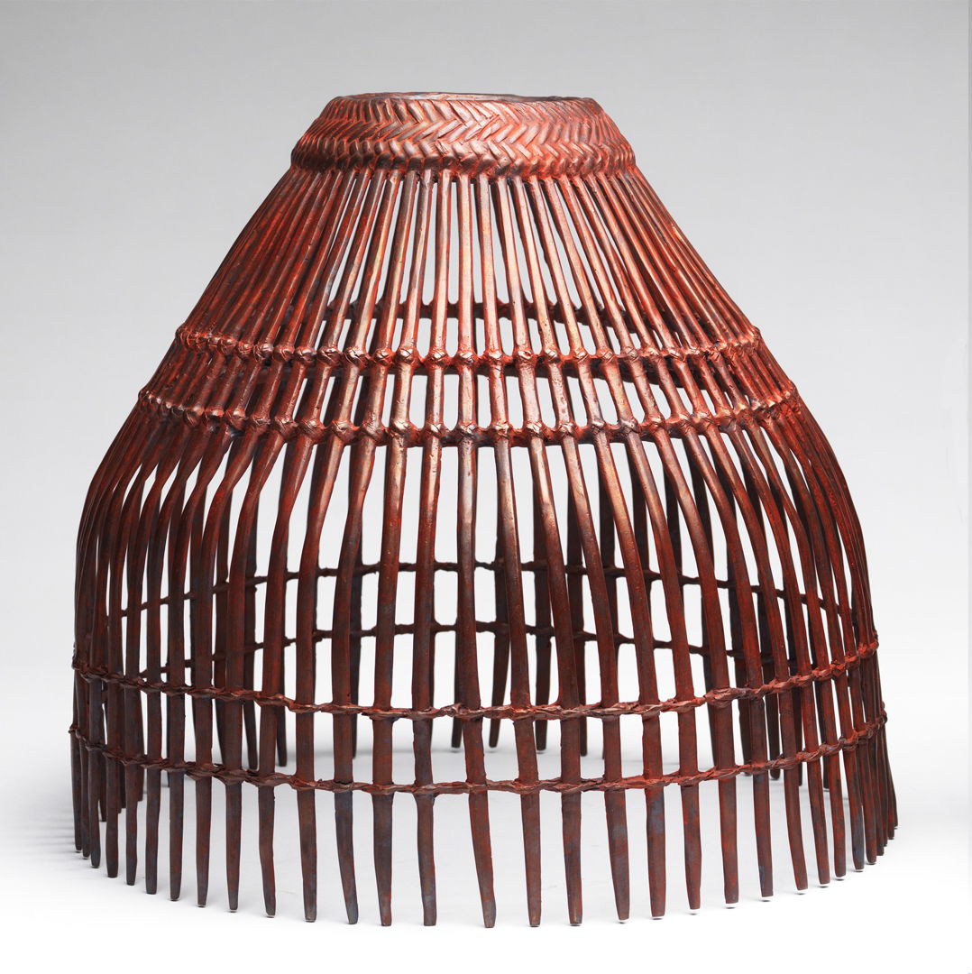 Cast bronze cage-like basket with sulfur patina and red pigment