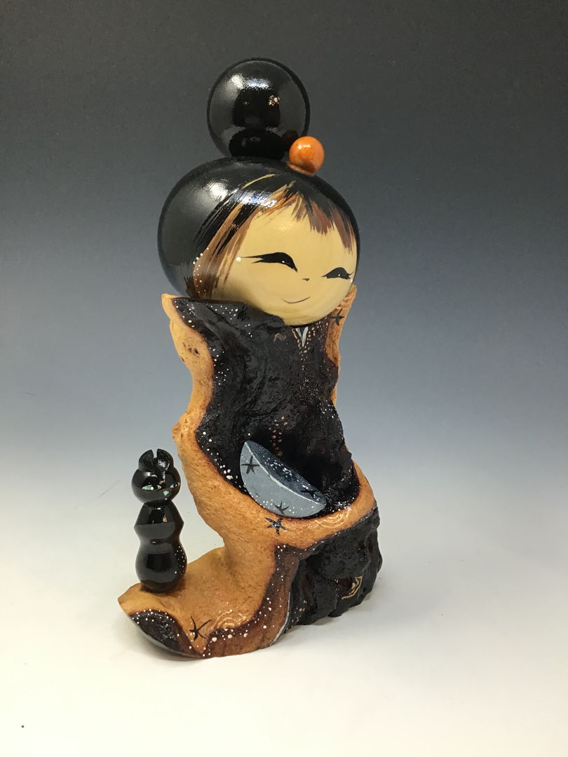 Mopani Kokeshi respectfully hold his Blackwood cat.