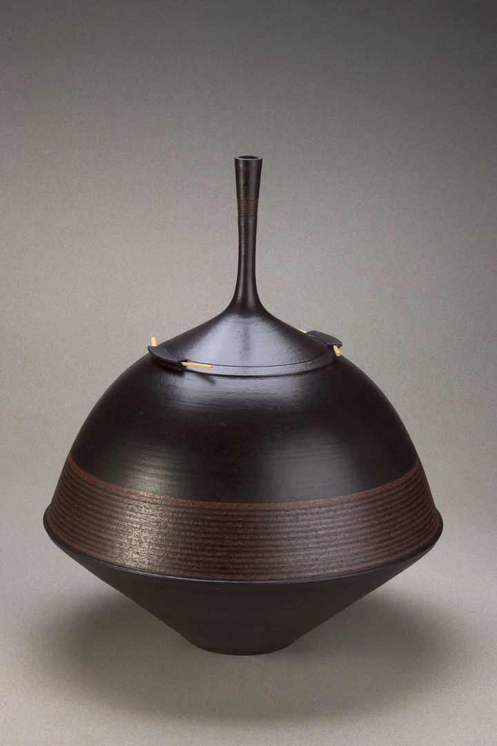 Thrown dark brown shiny terracotta vase with black accents.