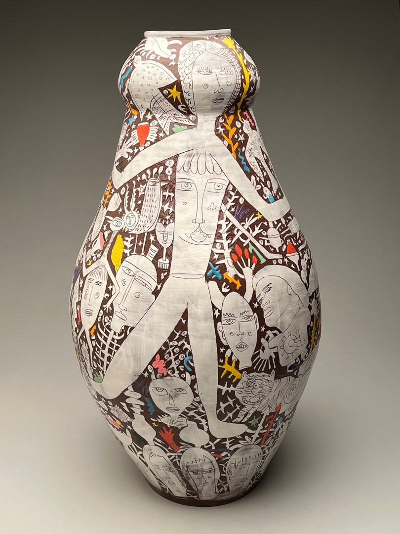 Ceramic vase with bold black and white illustrations of human figures and accented with occassional bright colors