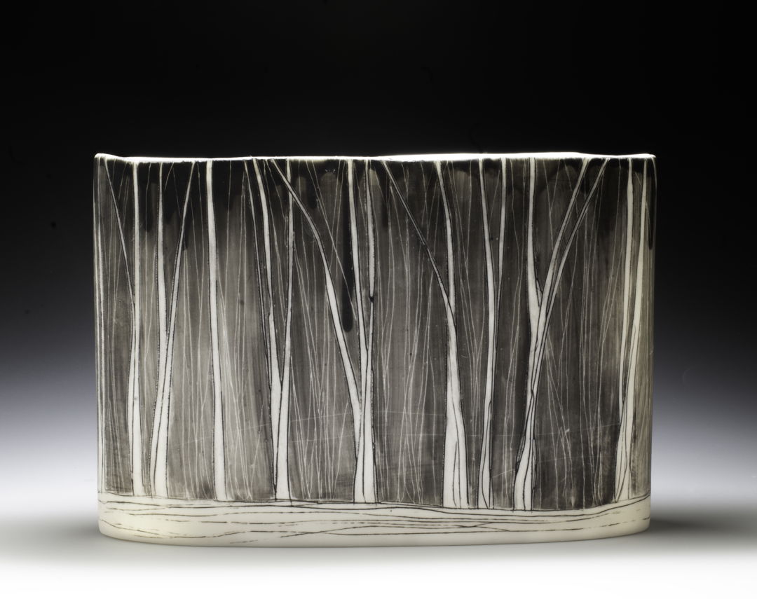 porcelain vessel with black linework resembling abstract trees.