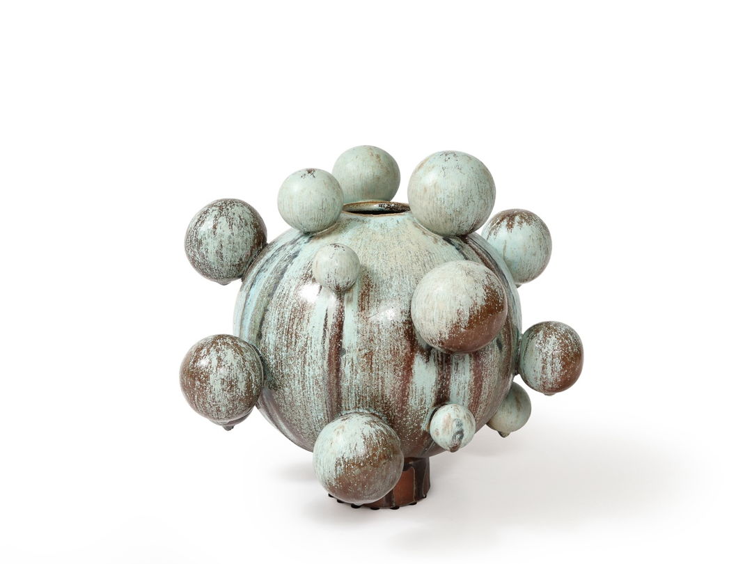 Imagined soft star form that feels like a natural object and a formal sculpture.Large soda fired vessel with soft ball extensions. Blue and brown matte crystals  with streaks of turquoise.