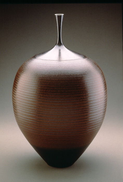 Thrown dark brown shiny terracotta vase with black accents.