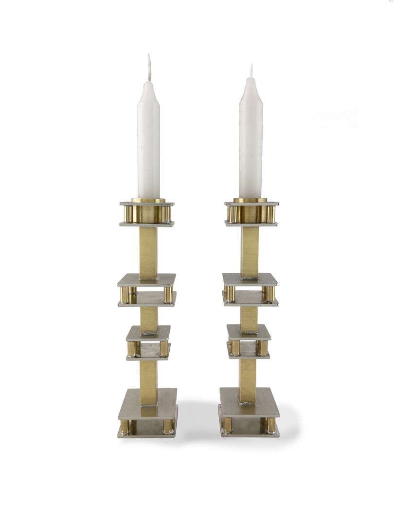 Hand fabricated from pewter and brass these stunning candle holders bring a delicate elegance to your dinner table.