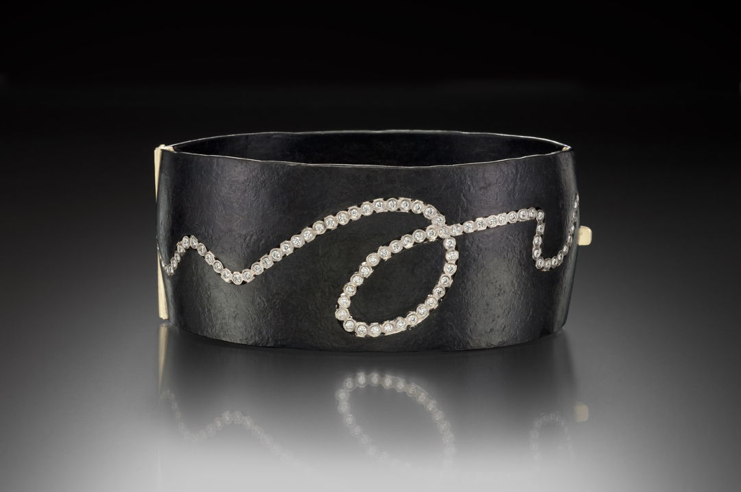 Formed and fabricated Iron locking cuff with an 18K Yellow Gold box clasp  and Diamonds set 18K Palladium White Gold bezels.