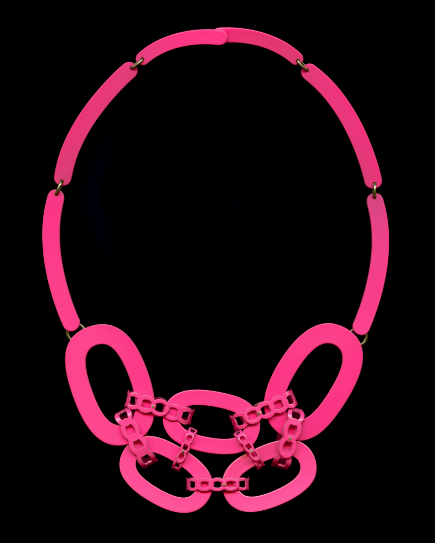 The Chaos Chain 02 is part of my Linked series and the design is based on the iconic chain link motif. I have exaggerated and manipulated different areas and drawings of a chain link to create a new necklace that speaks to the history or jewelry but with a contemporary aesthetic. The necklace is hand-cut from brass  hand fabricated and powder coated hot pink.