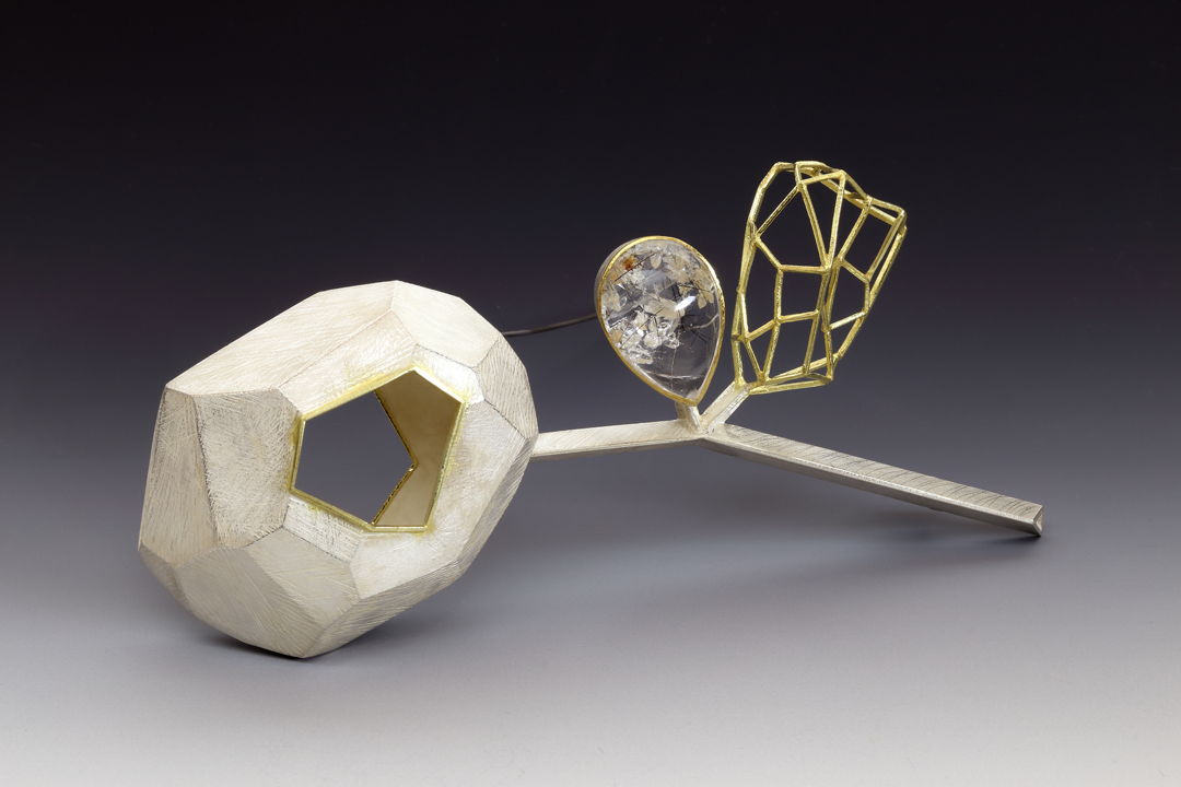 The quartz in between the hollow form and the wire structure shows the lovely connection and the chemistry of the two individuals. The negative space and the see through element reflect the color and the emotion of the wearer when worn. It also evokes the curiosity of the viewer.