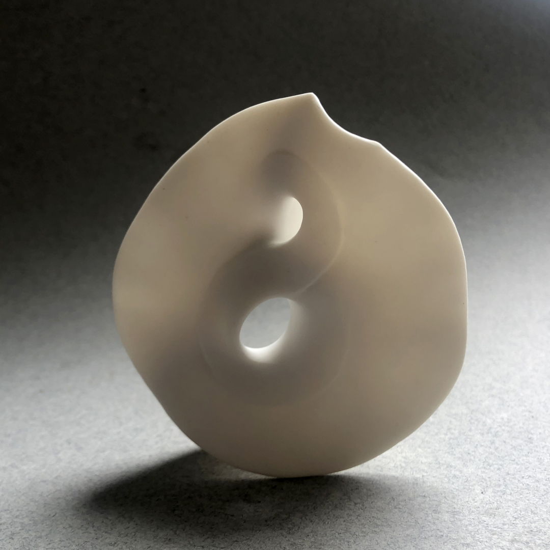Porcelain twisting mobius piece. It has a unglazed surface.