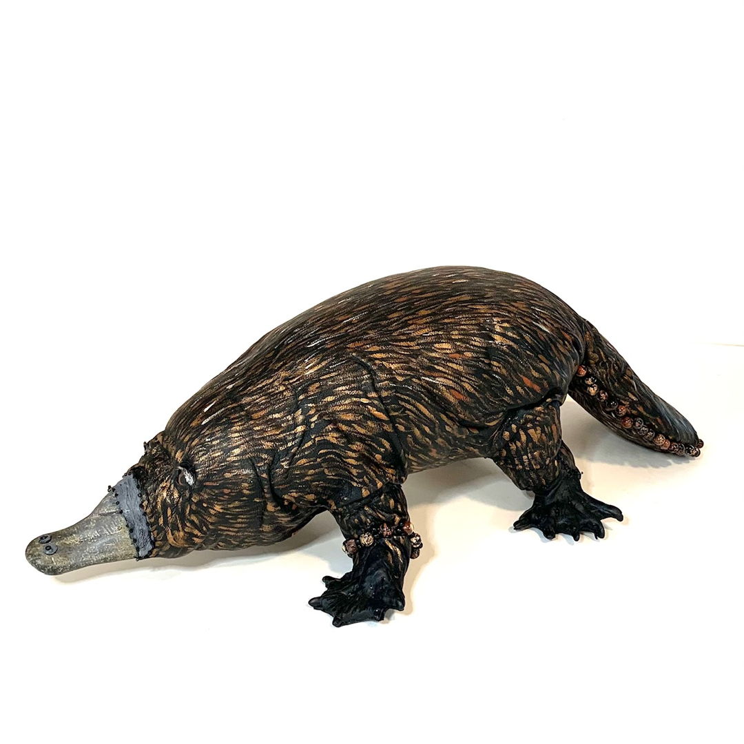 Platypus-inspired leather sculpture with stone "bill"  wire armature  apoxy sculpt/wire webbed feet  glass eyes  painted "fur"