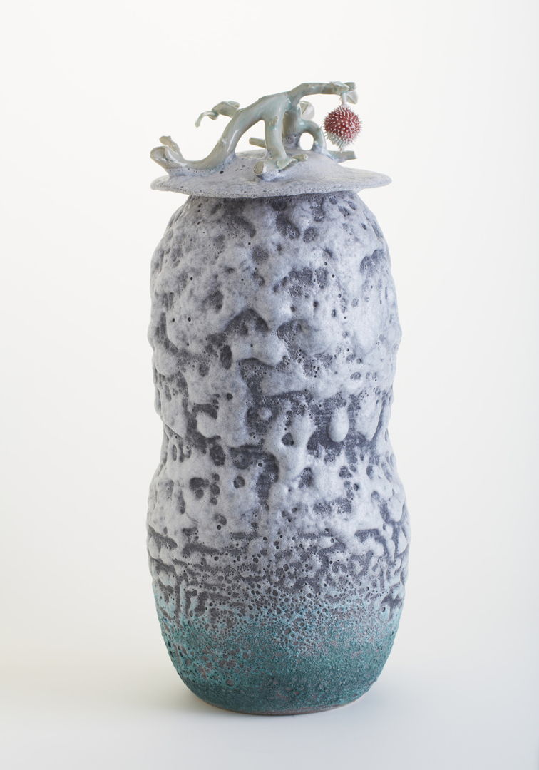 porcelain vase with lid and glaze with laza rock effect.