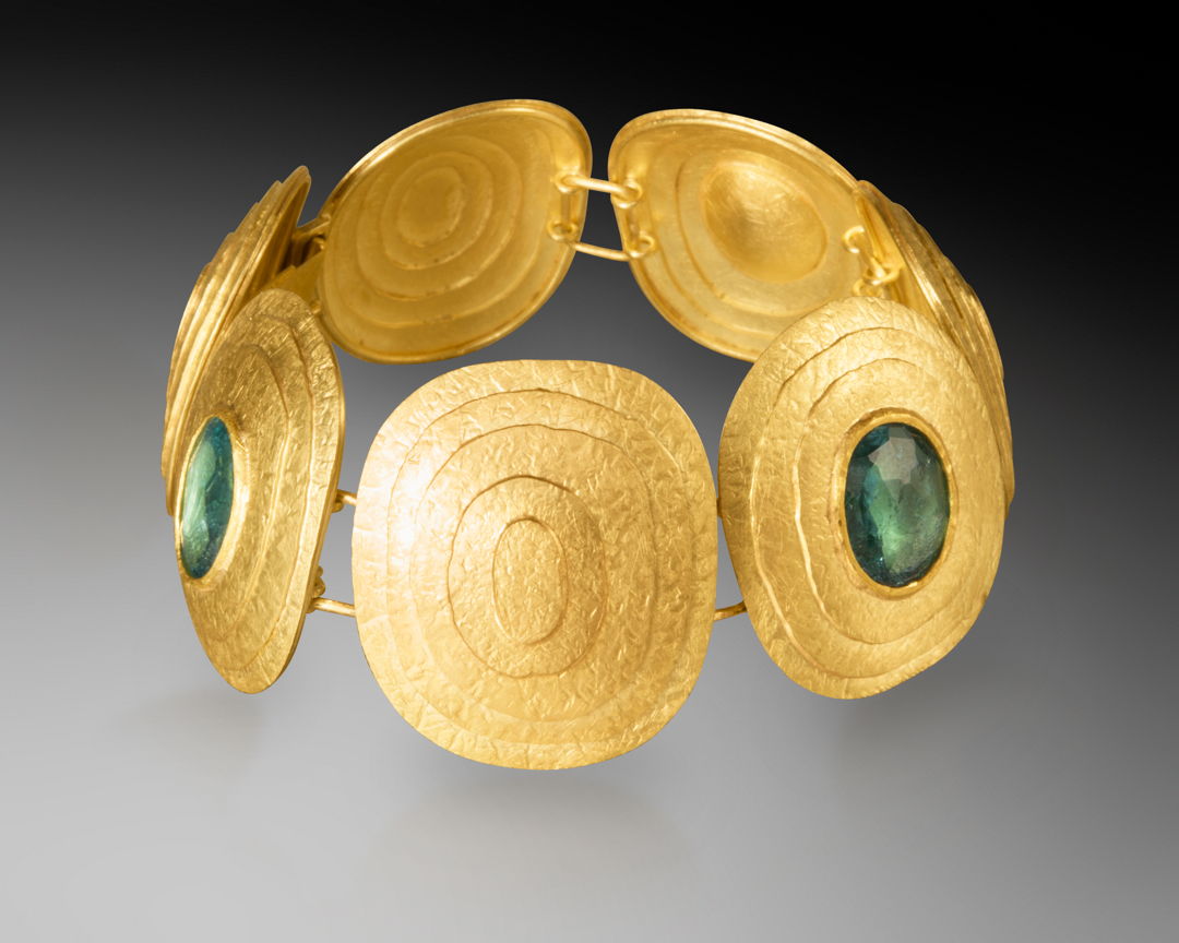 Rosecut green tourmalines (8ct total) set in 22k gold bezels with 18k backing and hand fabricated concentric "zen garden" circular design.