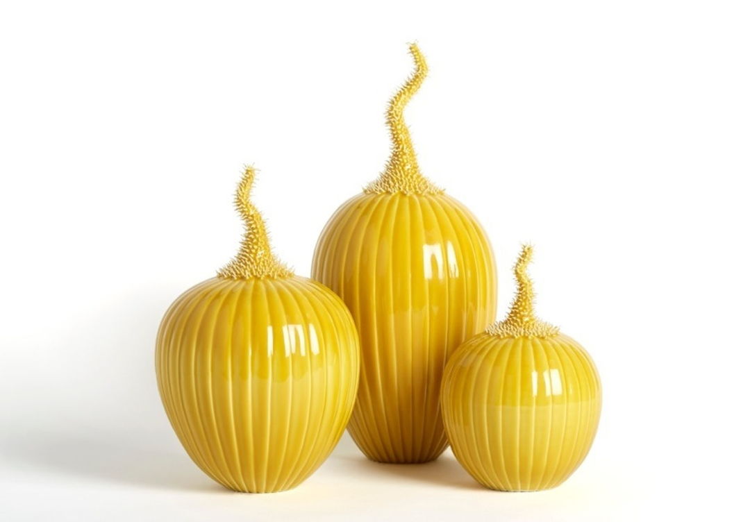 Three yellow pumkin shaped sculptures with spikey upwards-reaching stems
