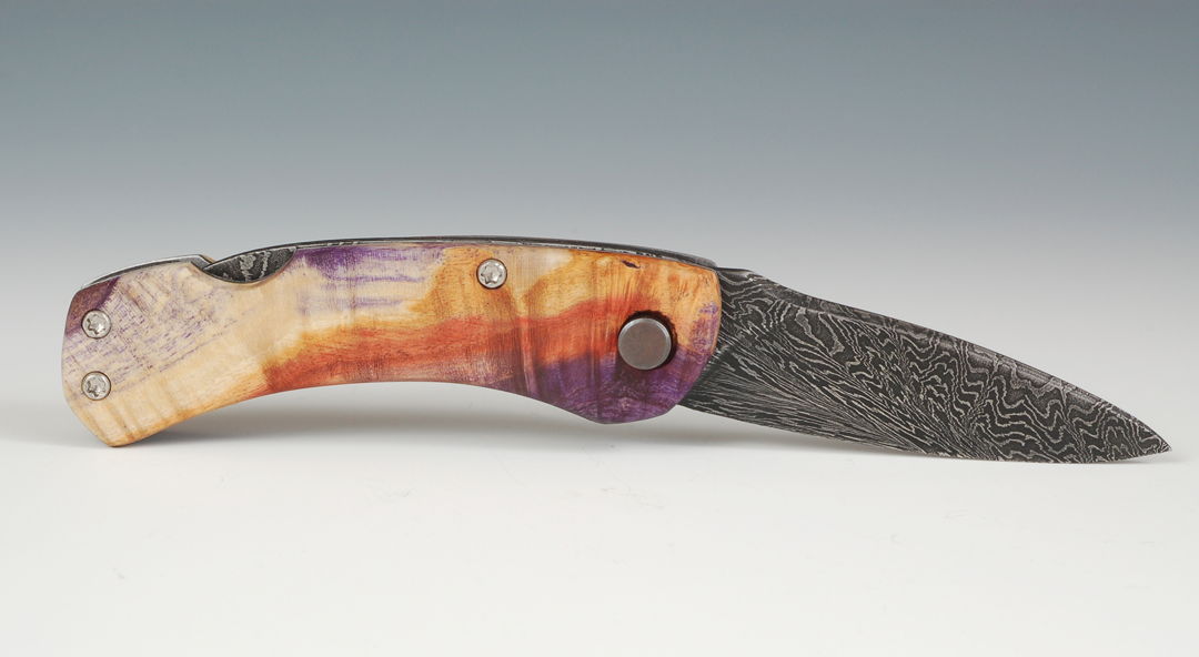 House made Damascus Steel tool steel forged and fabricated into a wonderfully functional folding knife. Handle is made of dyed and stabilized box elder burl.