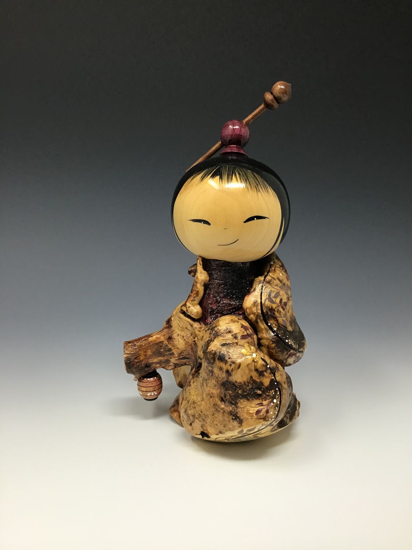 Kokeshi made from Buck Eye burl  Maple  Tulip Poplar and Rosewood holding the lantern that shows the way.