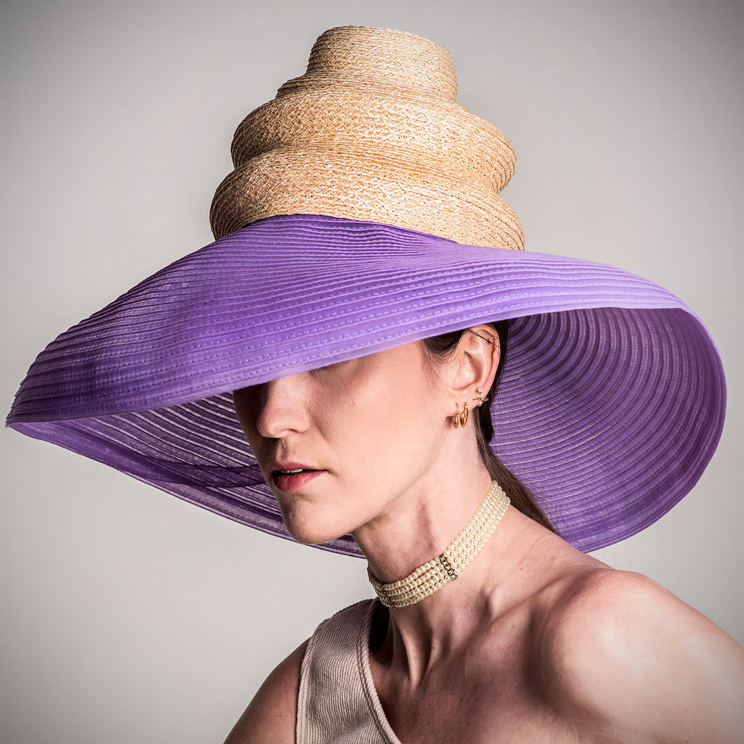 I love the drama  yet simplicity of the piece. I created the crown  shaping it as I build it with tension on braid as feeding into needle. It is 9 mm natural hemp straw. The brim is a Swiss tubular horsehair  11 mm wide. I create some curve at the edge for classic brim shape.