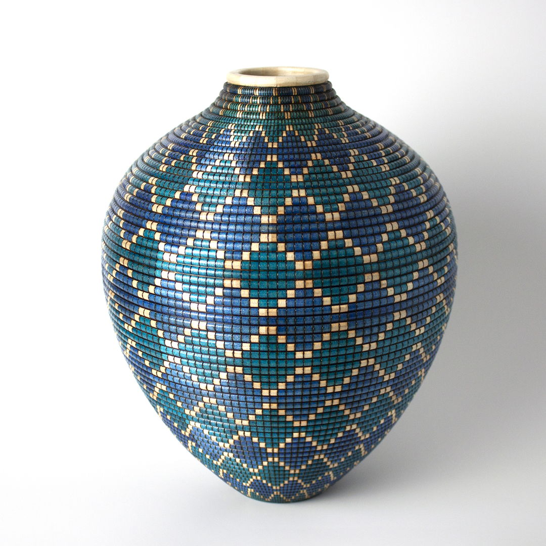 Turned and hollowed Maple vessel embellished with pyrography and hand-dyed with archival ink to give the appearance of a woven basket.