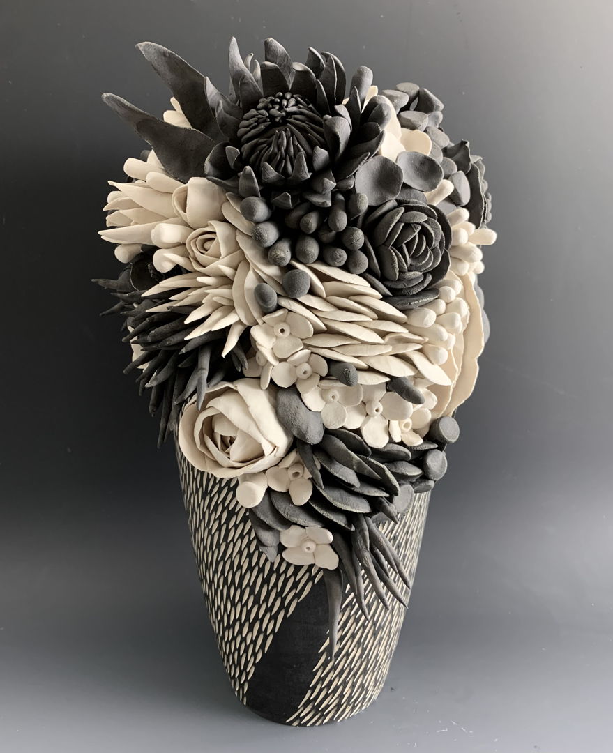 black and white porcelain vase with porcelain flower arrangement,