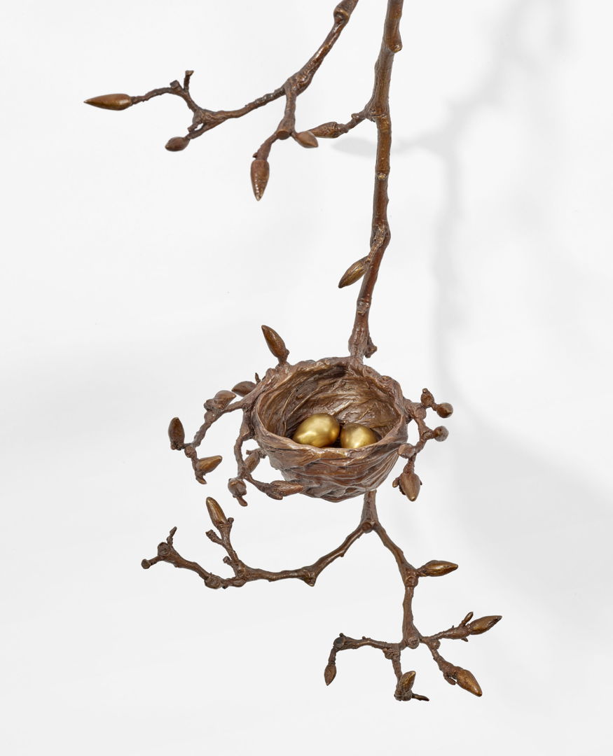Cast bronze sculpture with a nest and eggs resting on a cascading Magnolia branch and luminescent antique brown patina.