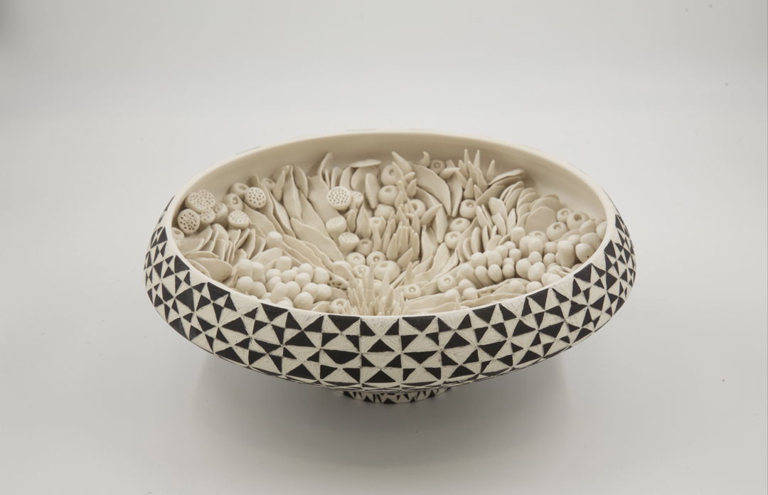 Made from porcelain on the wheel hand carved handmade embellishments high fired.