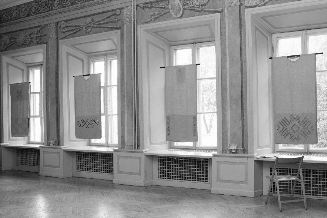 four 2D vestments hung in a meeting hall of Vilnius Art Academy of Lithuania