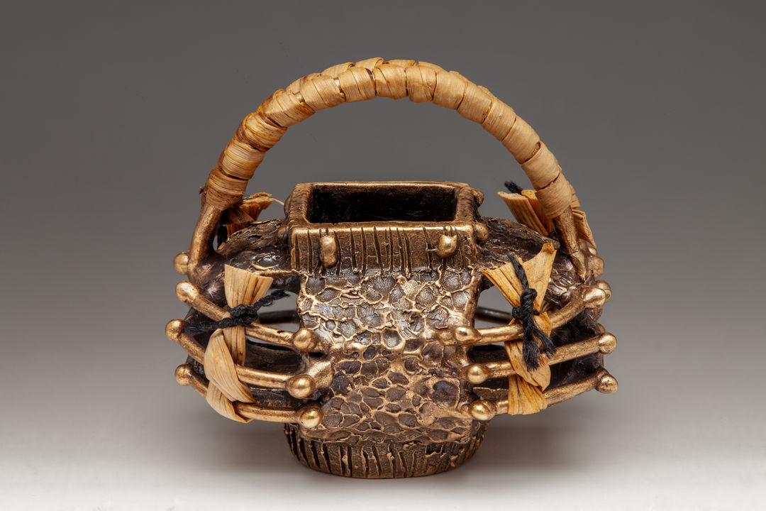 Cast bronze basket with woven and twined sweet grass