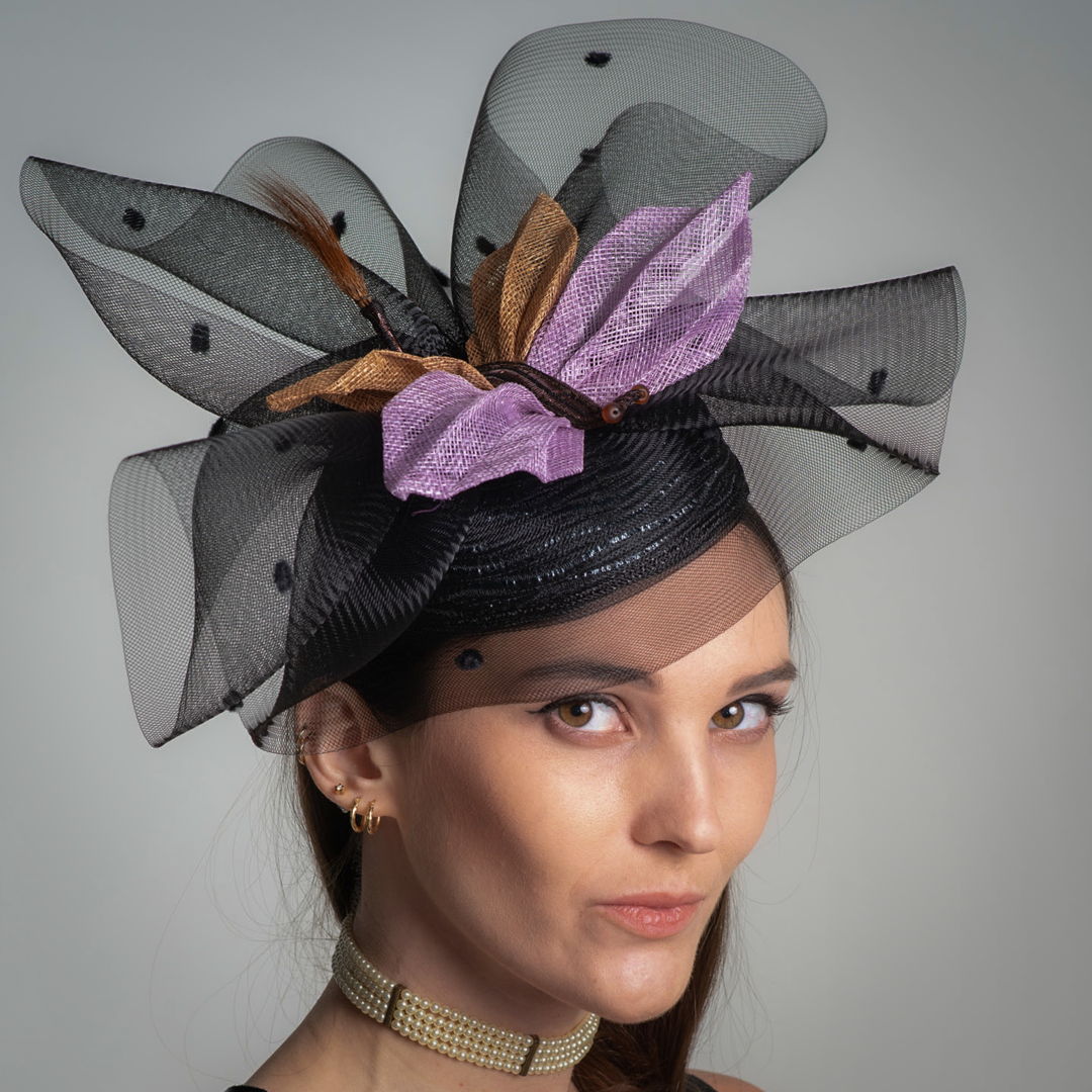 This cocktail hat has 3 parts to it. First  the base I made from 11 mm Swiss tubular braid  edged with horsehair and single strand of Paglina braid. The mid section is 14 inch horsehair with chenille dots which I gathered and layered. The dragonfly I put together with bias cut squares of synamy fiber  pleated them  for the wings Wire  bead and feathers for accents.