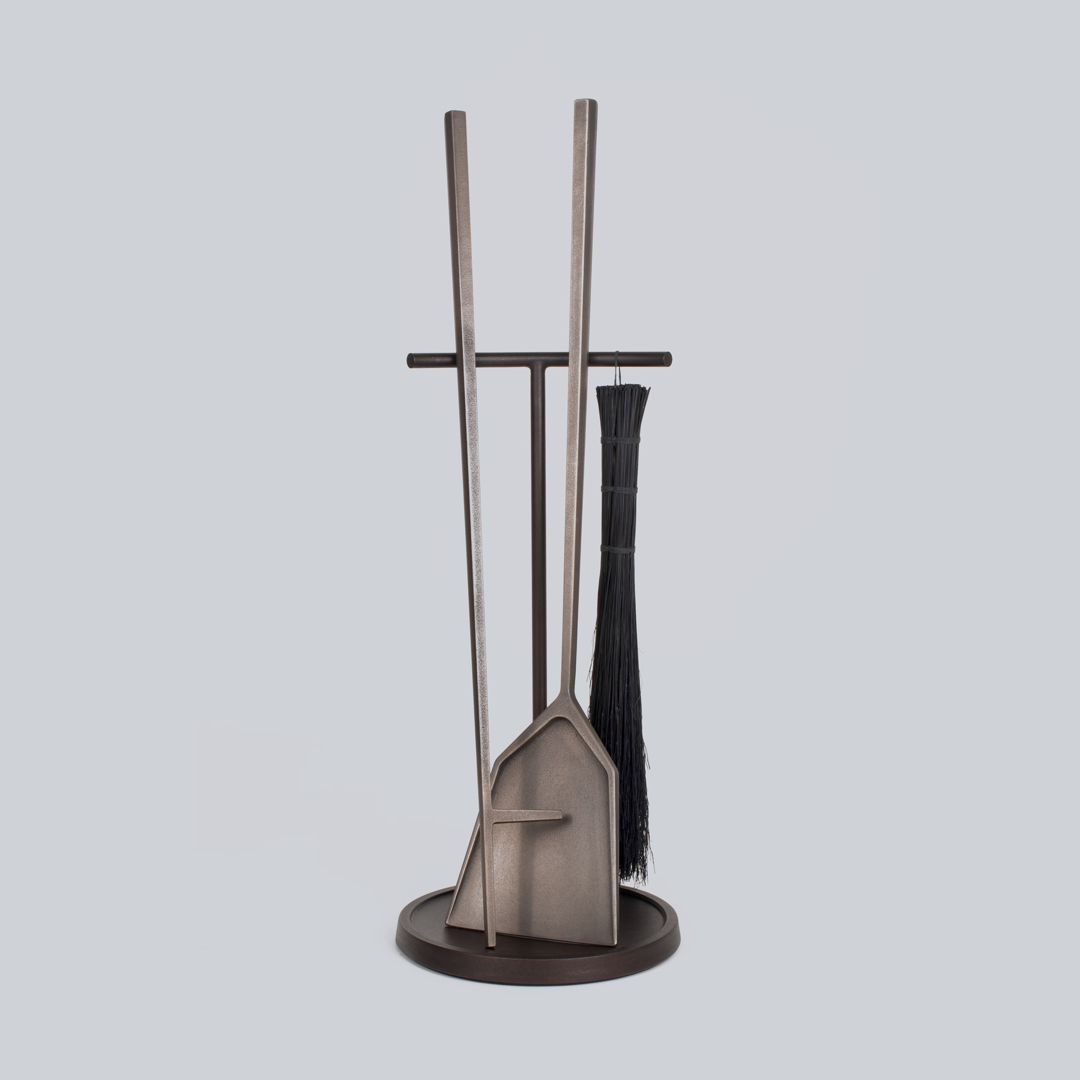 Cast in silicon bronze  our Hearth Tools have a burnished finish that will naturally patina over time. The stand  made from steel and seasoned cast iron  has a Horween leather pad (scrap from a local shoemaker) to protect the floor from its heavy base. The brush  a tied bundle of broomcorn  is designed to be used and replaced  if need be. When the brush has worn out  simply toss it into the fire. Offered in multiple finishes and three sizes  shown here in oxidized bronze.