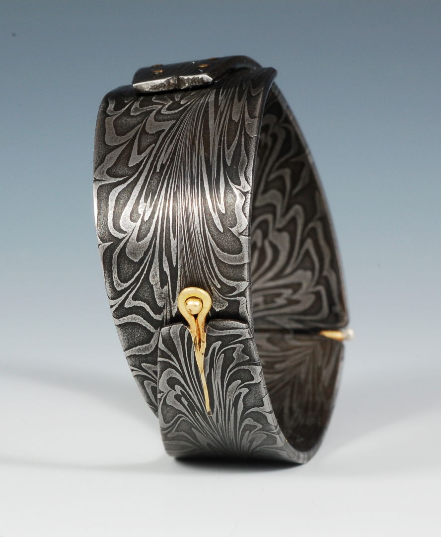 House made Damascus steel with 18K gold formed into a cuff