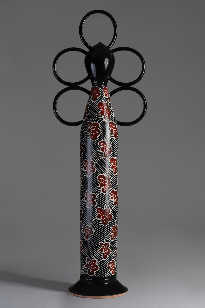 tall ceramic sculpture with floral decoration