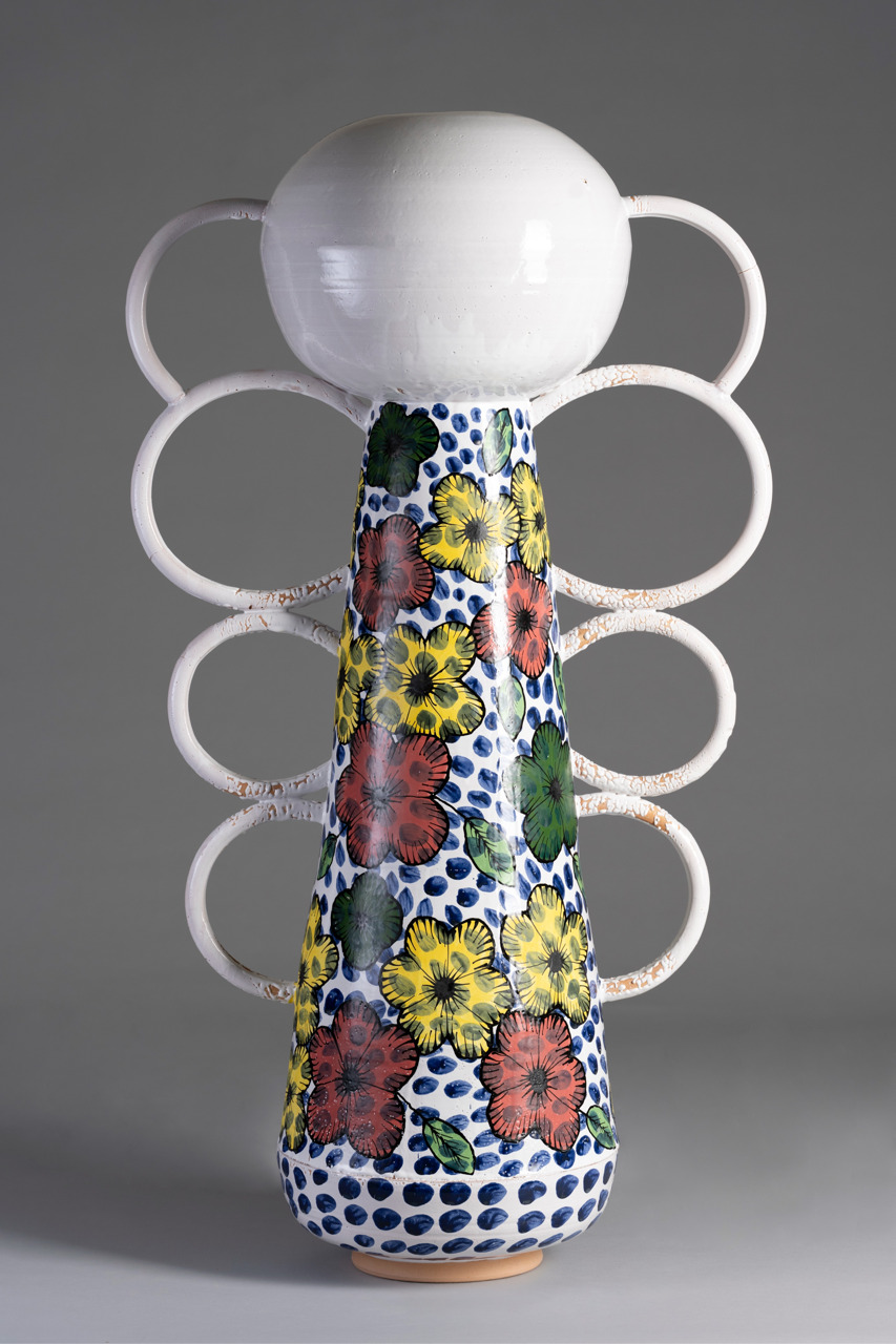 vertical sculpture with orb at top and circles lining either side