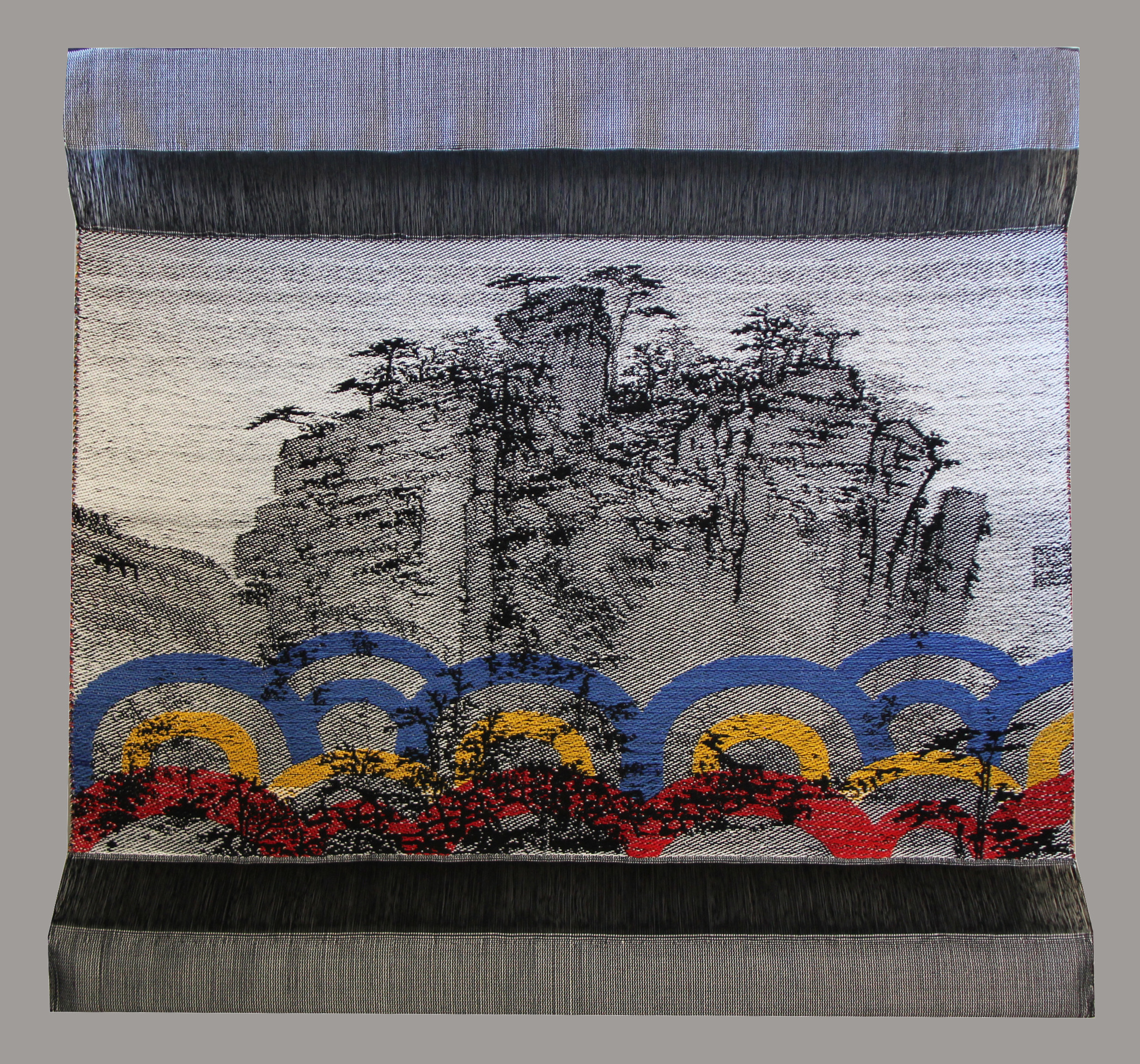 woven image of cliffside with colorful accents