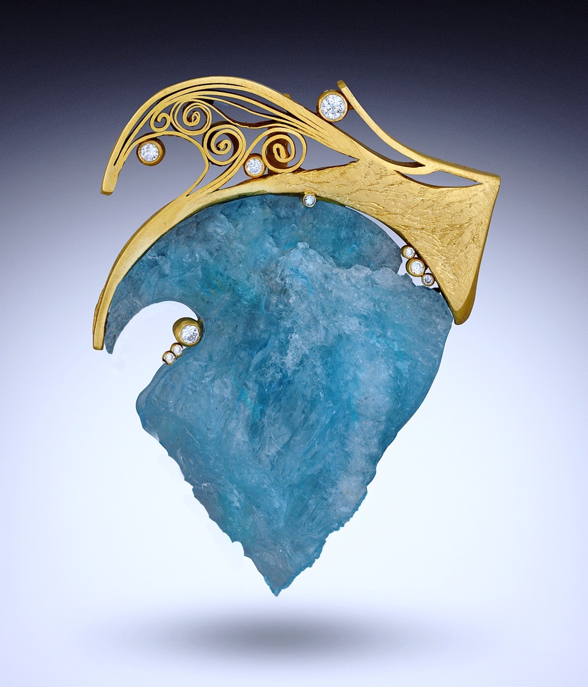 brooch with large trianglular blue stone