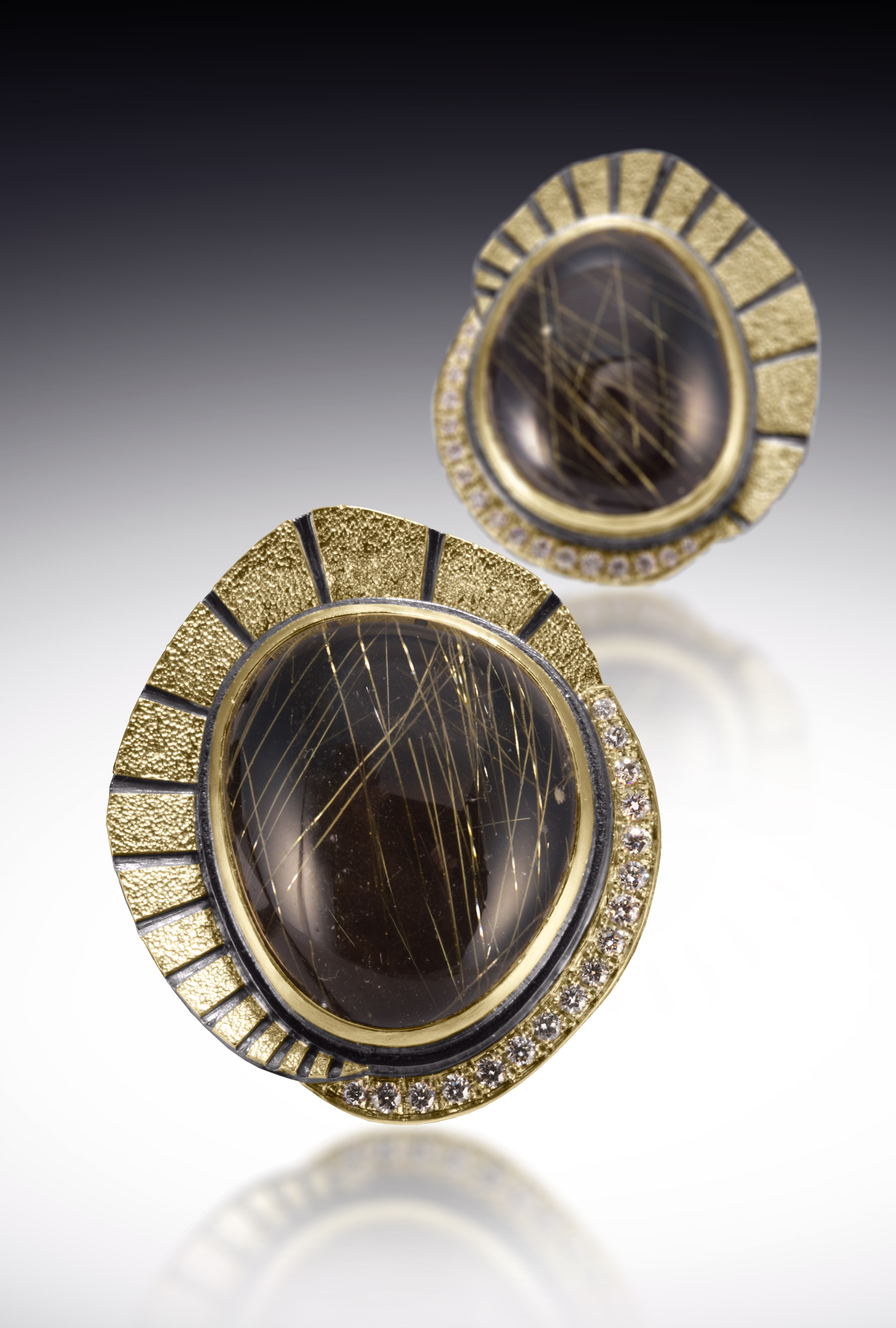 two stones surrounded by gold