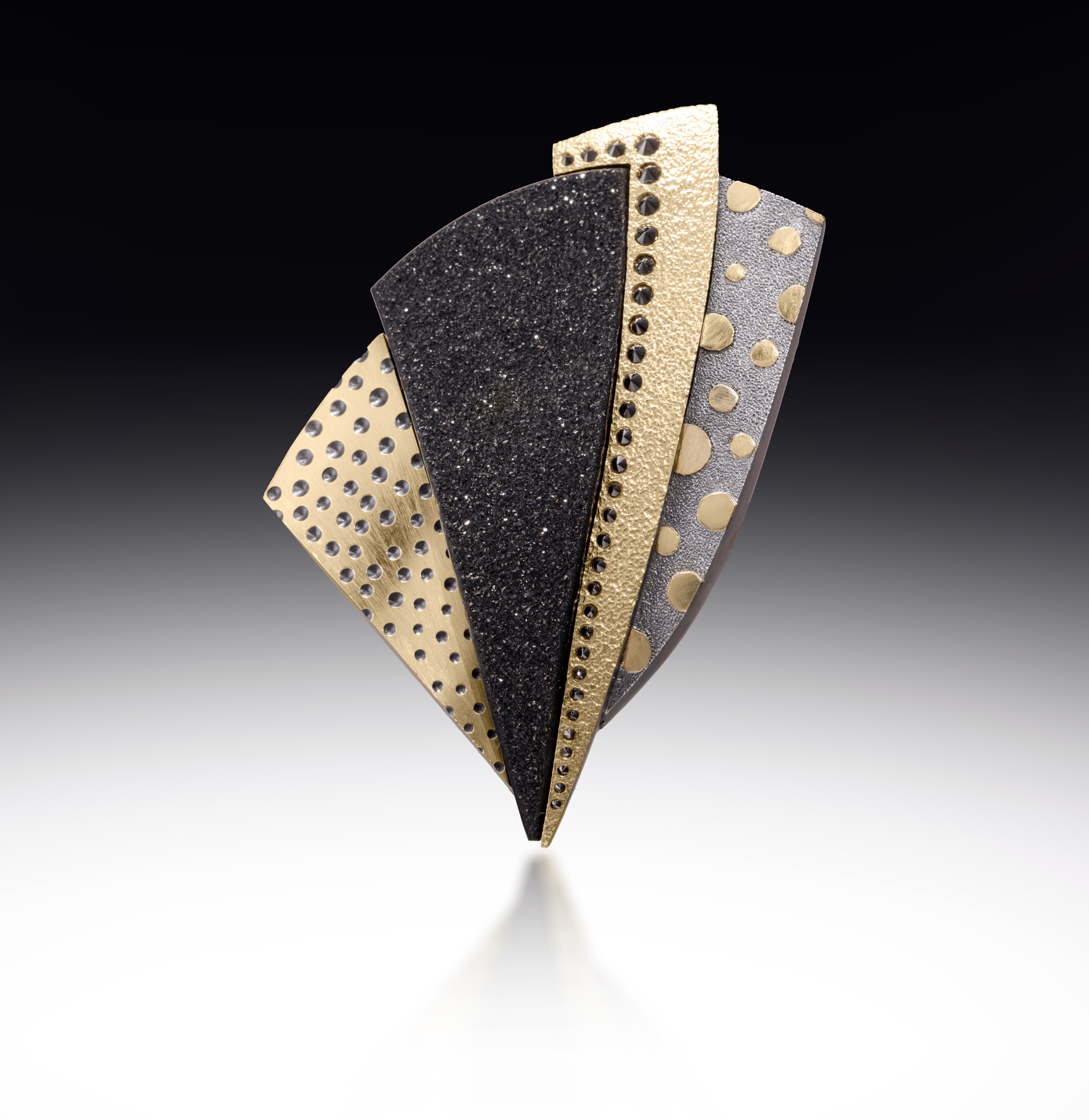 brooch with different textured metals